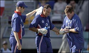 Nasser Hussain is tended to by the England physio's as he suffers from cramp