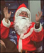 A football fan dressed as Santa Claus