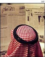 Saudi man reading newspaper