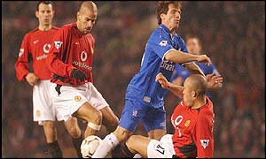 Chelsea's Gianfranco Zola is tackled by Mikael Silvestre