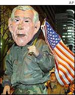 Protestors carry an effigy of the US president 