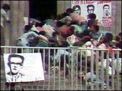 Crowds scramble towards the cathedral entrance as police open fire