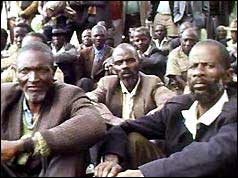 Crowd of black Rhodesian men seated on the ground