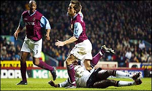 Villa are awarded a penalty when Djimi Traore trips Lee Hendrie