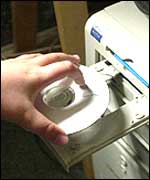 Someone putting CD in CD ROM