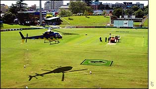 A low-flying helicopter dries out the pitch before play can start on day two