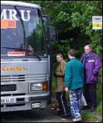 Passengers board a replacement bus