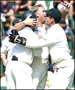 Shane Warne is mobbed by team-mates