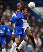 Jody Morris of Chelsea challenges Aston Villa striker Dion Dublin for the ball