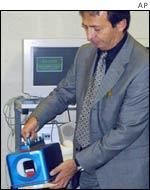 An official of the International Atomic Energy Agency holds a surveillance camera