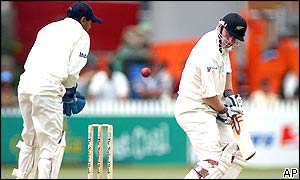 Indian wicketkeeper Parthiv Patel gathers the ball as New Zealand batsman Scott Styris watches it pass him