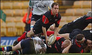 Kyran Bracken of Saracens passes the ball out of a ruck