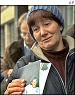 Woman holds photo of her relative being held hostage