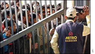 Impatient passengers waiting beyond the barrier