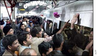 Passengers rush to board a metro train