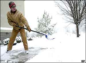 Man clearing snow from the pavement in Bella Vista, Arkansas