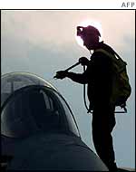 Sailor hoses down jet aboard USS Constellation in the Gulf