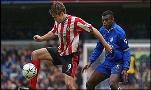 Southampton's James Beattie holds the ball up ahead of Chelsea's Desailly