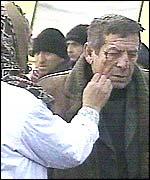 A woman cleans blood off a man's face after the bombing in Grozny. Picture: TVS television channel