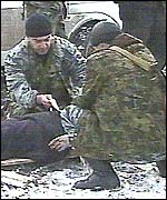 A casualty of the Grozny bombing lies on a makeshift stretcher. Picture: TVS television channel