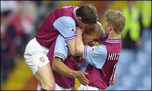 Dion Dublin is mobbed by his team mates 