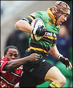 Gloucester wing Marcel Garvey hauls down Northampton wing Bruce Reihana