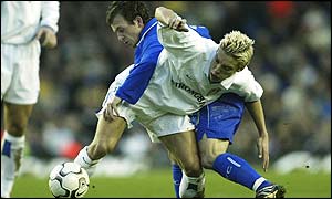 Alan Smith of Leeds and Albert Ferrer of Chelsea tussle for the ball