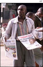 A newspaper seller reveals the election result