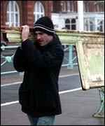 People carrying debris away