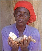 Zambian woman holding roots and barbs