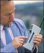 Man with big, old mobile phone