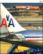 An American Airlines plane sits on the runway after being diverted following an attempt by a passenger to light explosives hidden in his shoes.