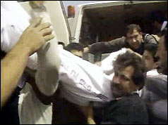 Body being carried away after shootings