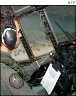 Australian air force crew assesses damage inflicted by the cyclone
