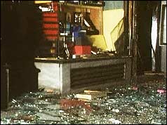 Broken glass and other damage to shopfront 