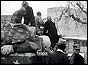 Refugees and belongings piled on army truck