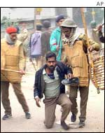 Police tackle a protester in Patna