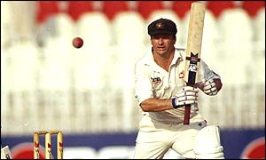 Steve Waugh watches the ball as he hits it through the covers