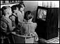 Children watching black and white TV