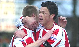 Danny Carroll is hugged after scoring one of Farnborough's goals in their win over Darlington