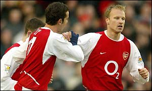 Dennis Bergkamp is congratulated after scoring his 100th goal for Arsenal
