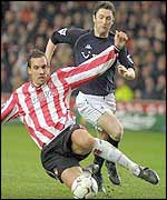 Southampton's Claus Lundekvam challenges Tottenham's Robbie Keane