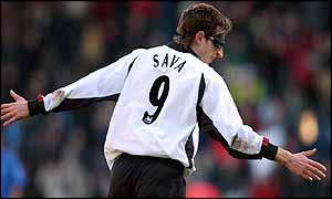 Facundo Sava runs to celebrate scoring wearing his trademark mask