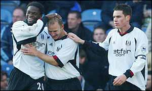 Bjarne Goldbaek is patted on the head by his team-mates after scoring Fulham's second goal