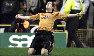 Mark Kennedy sinks to his knees in celebration after converting Colin Cameron's cross