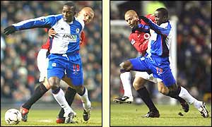 Blackburn's Dwight Yorke shields the ball from Wes Brown of Manchester United