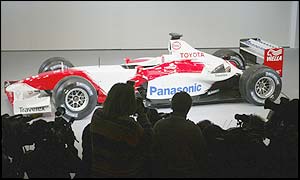 A large crowd gathers to watch the launch of the car