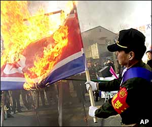 South Korean military veterans burn a North Korean national flag during their rally to support US military presence in South Korea