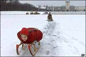 Children play on the frozen lake in front of Berlin's Charlottenburg Castle 