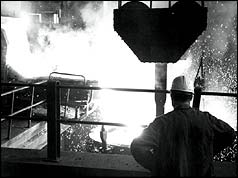 Steel worker in front of furnace